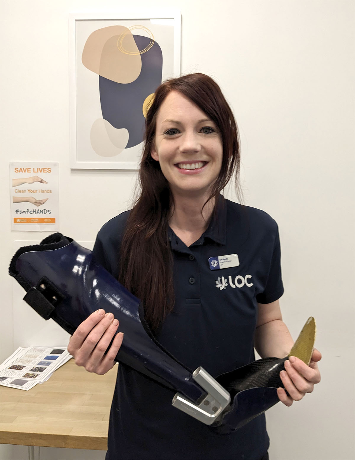 Catherine Hendy apprentice orthotist at the London Orthotic Consultancy holding a carbon fibre AFO