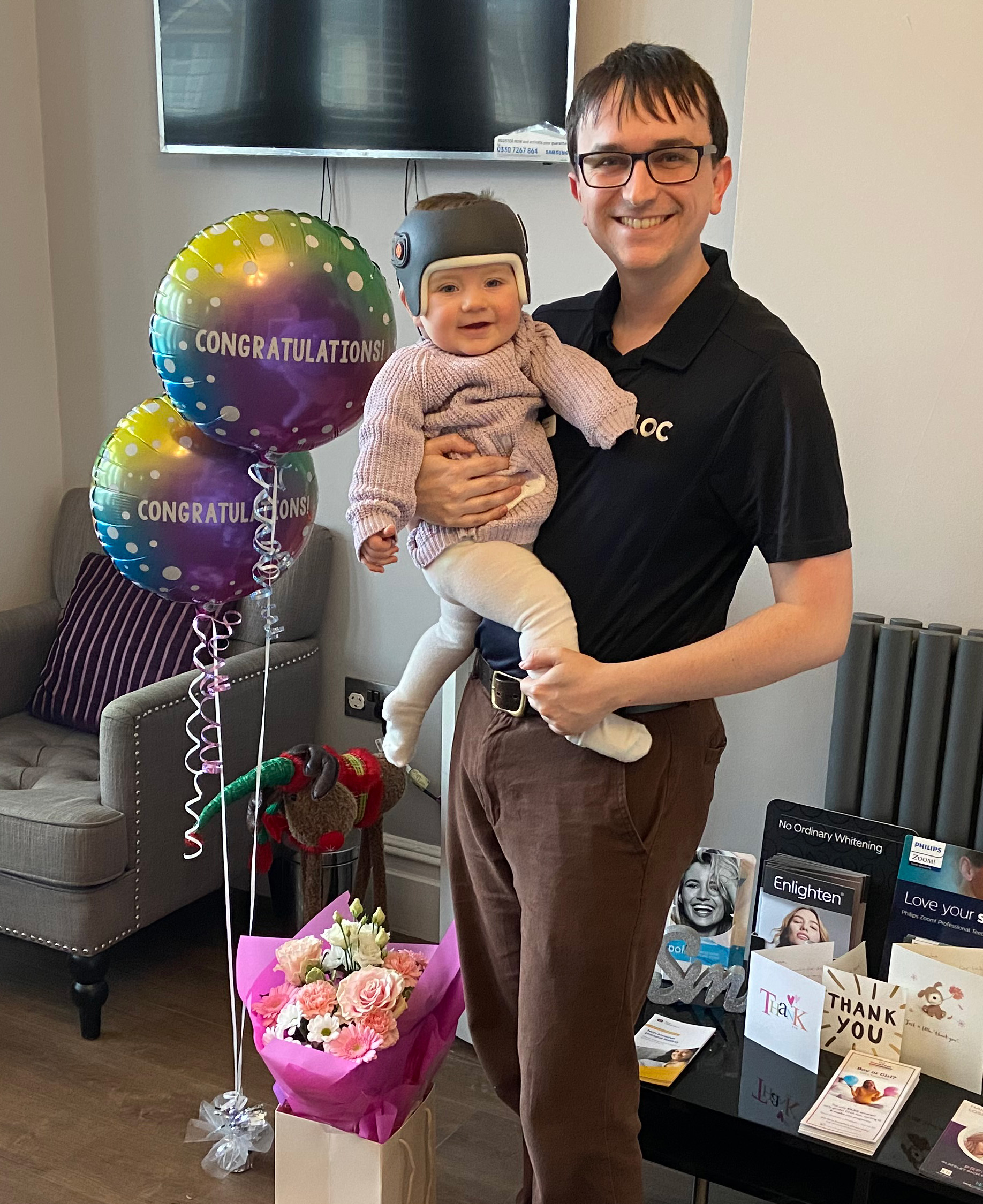 Orthotist George Coles and baby Autumn after completing her helmet therapy journey